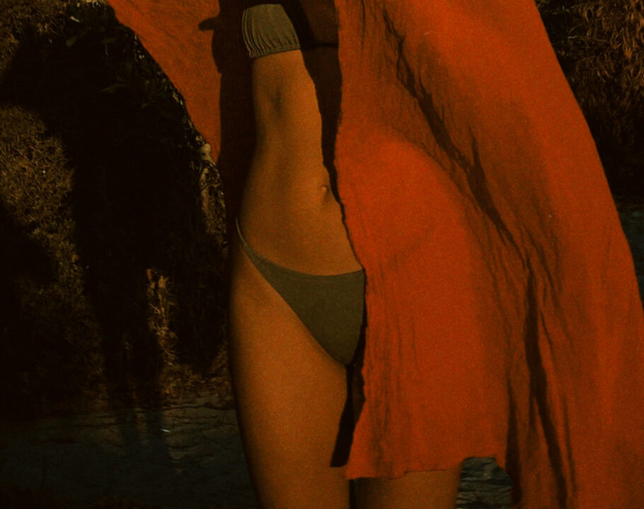 lower body of woman in bikini with orange towel
